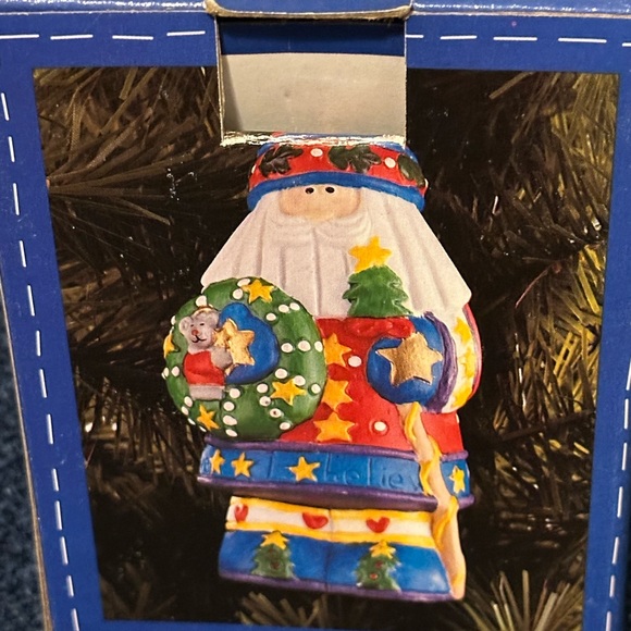 Brightly colored ceramic Santa ornament. Santa carries a tree & wreath. - Picture 2 of 10